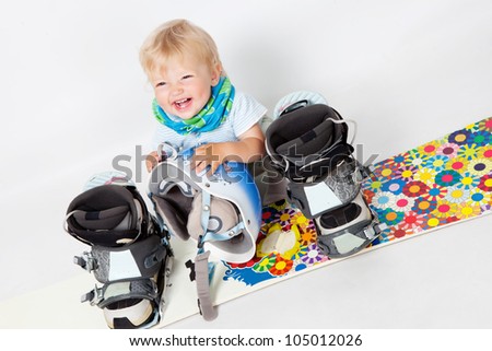 Little girl with snowboard in studio
