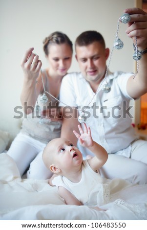 Mother and father playing with his son