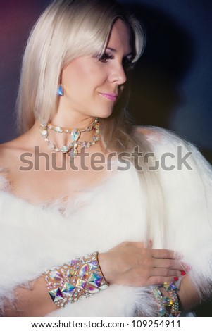 Beautiful blond hair woman in a fur dress