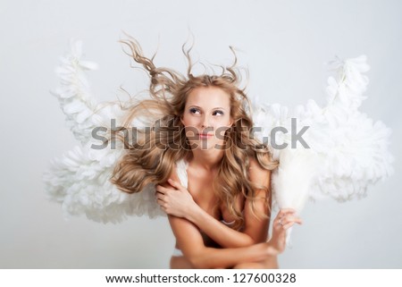Beautiful woman with angel wings in white underwear