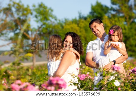 Happy family in blossom rose garden