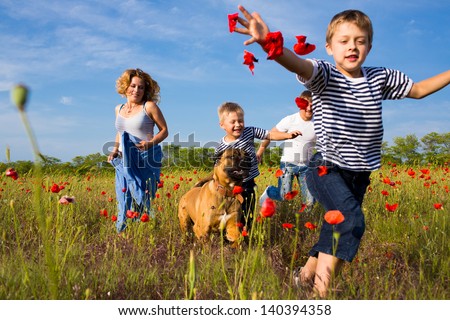 Family Of Four Person Playing On The Poppy Field