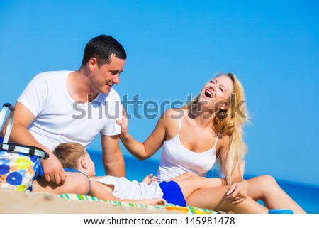 Family of three person on the beach
