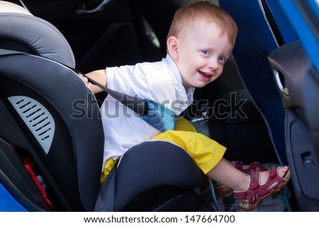 Child sitting in the car baby seat