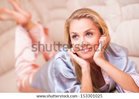 Beautiful young woman lying on couch