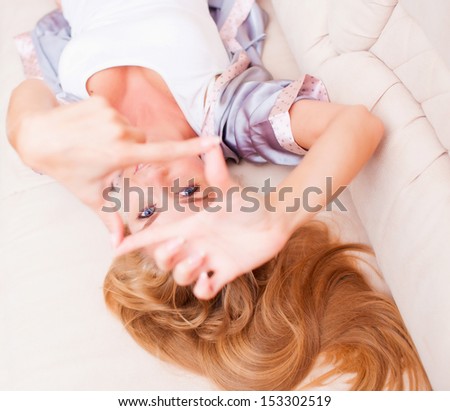 Beautiful young woman lying on couch