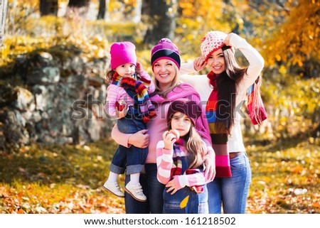 beautiful family on walk in autumn park