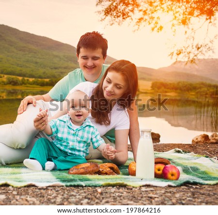 Happy family have picnic on the lake
