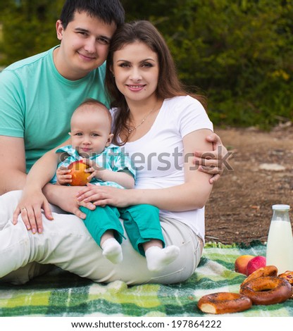 Happy family have picnic on the lake