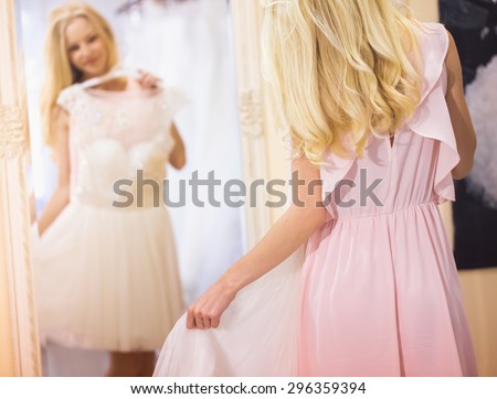woman is choosing a wedding dress in the shop