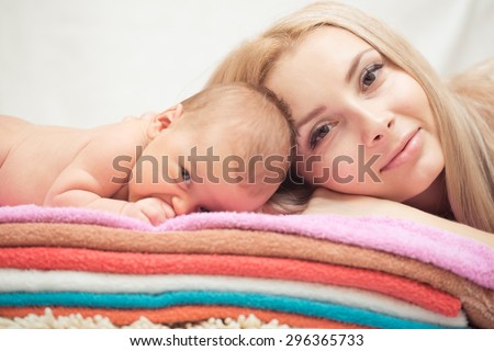 Mother and her Newborn Baby. Happy Mother and Baby kissing and hugging. Maternity concept. Parenthood. Motherhood