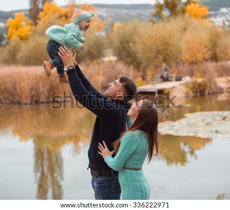 Young family resting on the lake shore