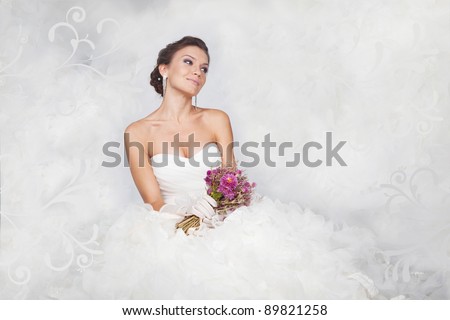 Brunet bride portrait with flowers in studio