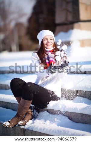 Girl playing with snow in park