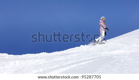 Young girl riding on snowboard