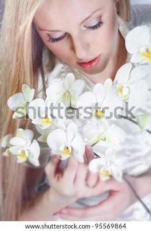 Girl with white orchid in studio