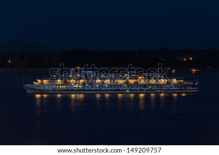 Cruise ship on the river. The ship on the night river