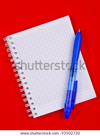 Pad of paper to take notes. Photo on a colored background