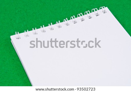 Pad of paper to take notes. Photo on a colored background