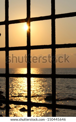 Metal Grid and Mediterranean Sea and Sunset, South Italy
