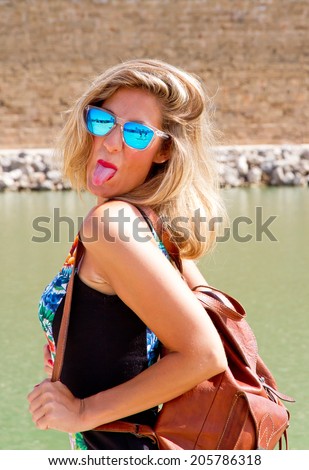 Tourist girl sticking tongue out