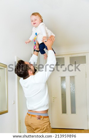 Father lifting baby girl