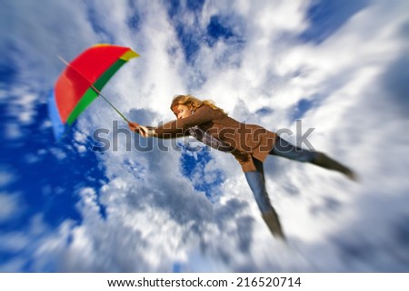 Woman flying with umbrella