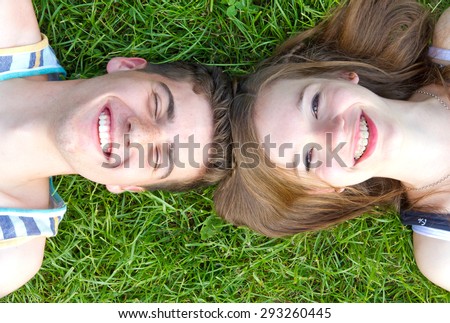 Happy love couple lying in the grass