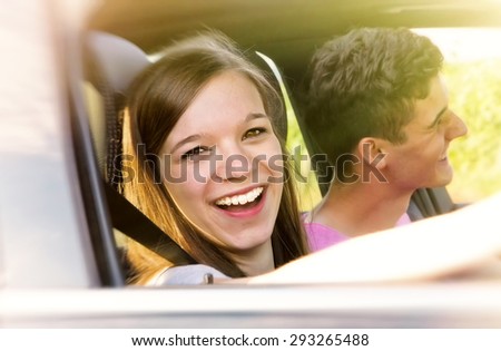 Happy couple driving in the sun