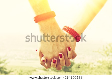 Couple holding hands on a sunny day