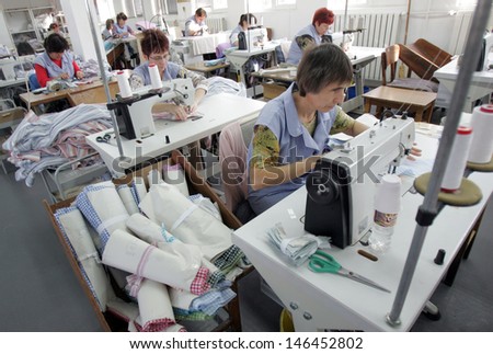 PAZARDJIK, BULGARIA - DECEMBER 13: Women ironed shirts in clothing factory, Dec 13, 2011, Pazardjik, Bulgaria.