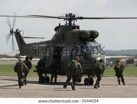 British Army soldiers board helicopters