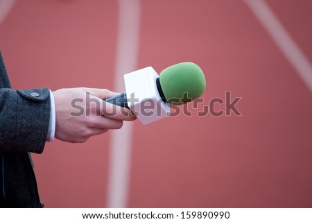 reporter holding microphone for interview