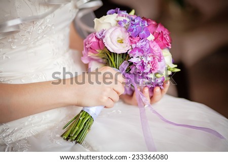 wedding bouquet in the hands of  bride