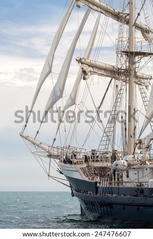 Old ship with white sales sailing in the sea Old ship with white sales sailing in the sea