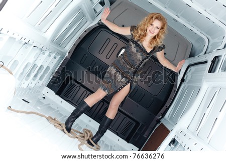 Pretty young woman in cargo van inside