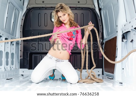 Sexy young woman in cargo van inside