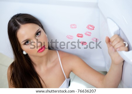 Young woman with New car with red kisses