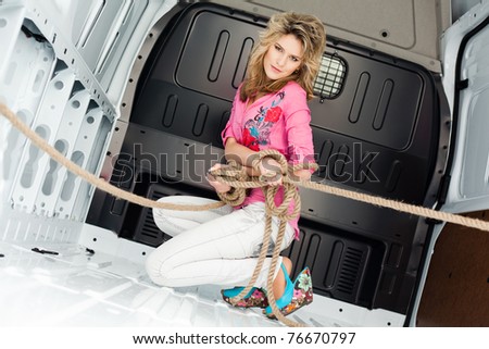 Sexy young woman in cargo van inside
