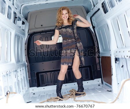 Pretty young woman in cargo van inside