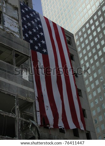 Large US Flag on building across from Ground Zero WTC taken on 9-18-2001  (left of WFC fallen atrium glass dome)