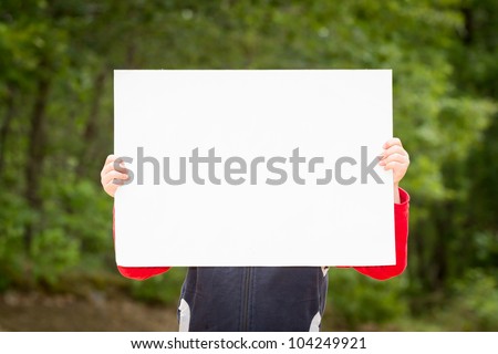 Kid holding empty paper in hands