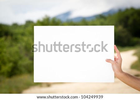 Man holding empty paper in hands