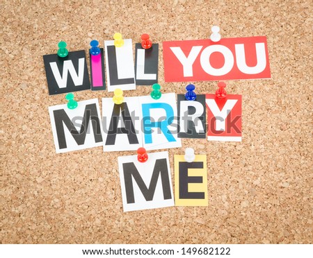 Will You Marry Me, pinned on cork bulletin board.