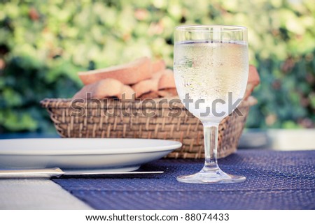 Plate, Glass and Knife on the dining table, outdoor.