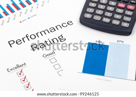 Pen, Glasses and Performance Rating Form on desktop in business office.