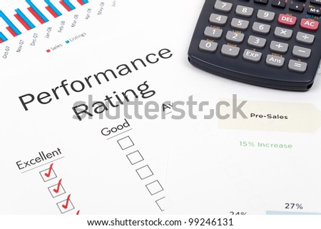 Pen, Calculator and Performance Rating Form on desktop in business office.