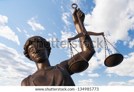 Statue of Justice on sky background