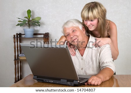 The grandmother and the grandchild behind the computer