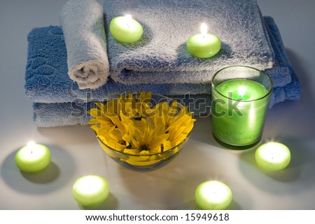 Candles, a towel and flowers for spa